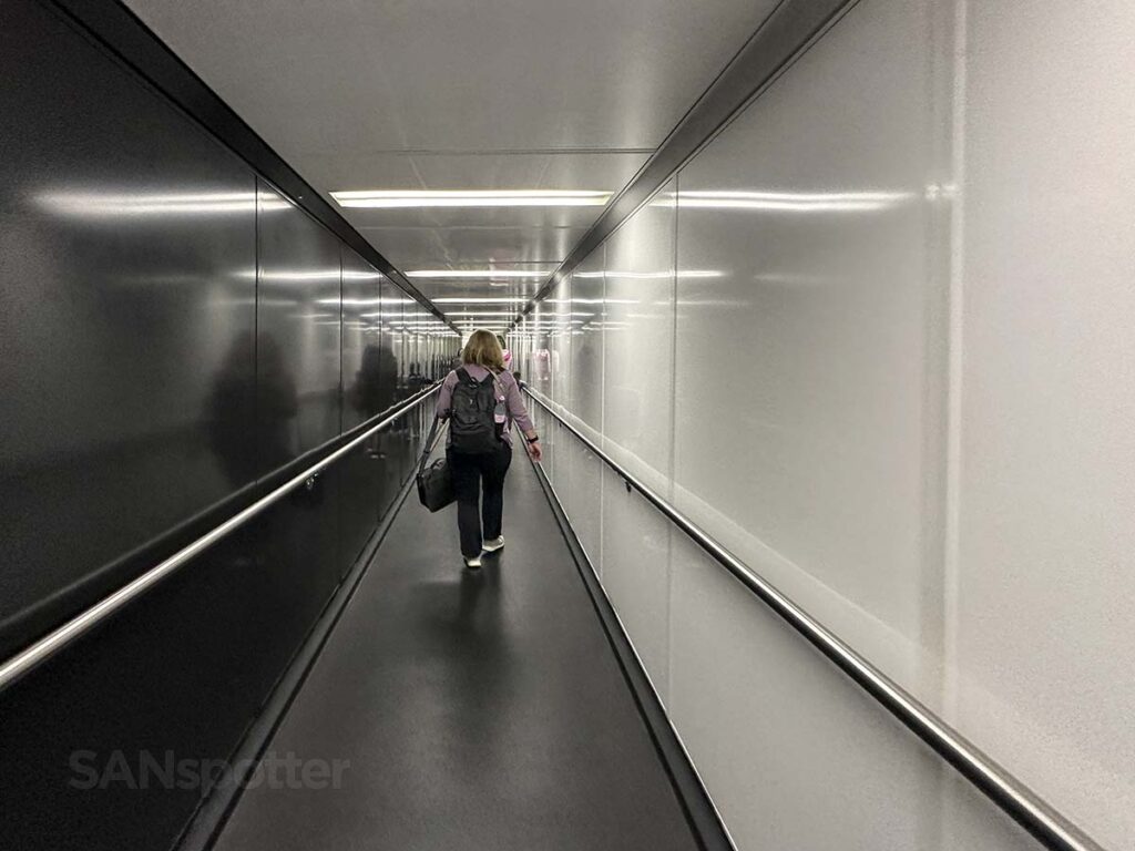 Passengers walking down gate 45 jet bridge San Diego airport