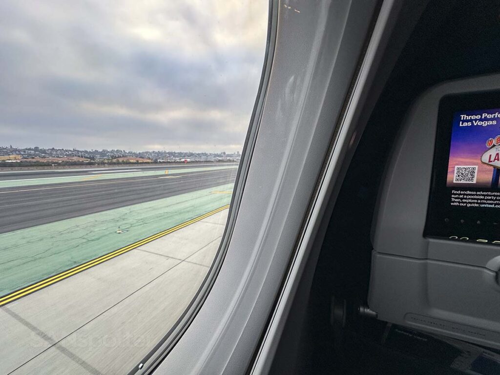 Looking forward out the window of seat 9A on a United A321neo while taxiing to runway 27 at the San Diego airport on a cloudy morning