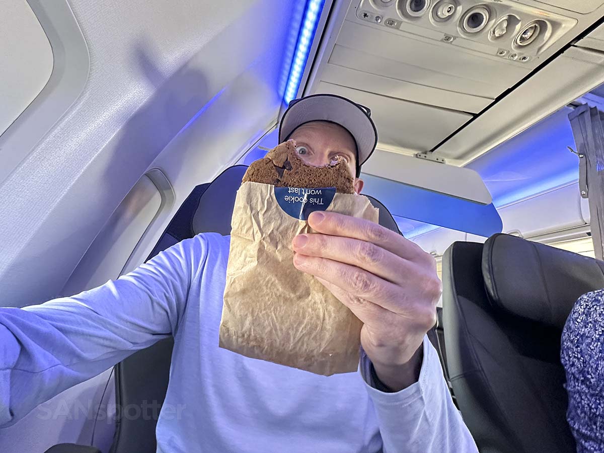 Scott Leazenby eating the hot fresh chocolate chip cookies served in Alaska Airlines 737-800 first class
