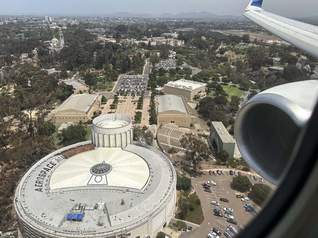 Looking out the window of an Alaska Airlines 737-800 overlying the air and space Museum while on approach into San Diego