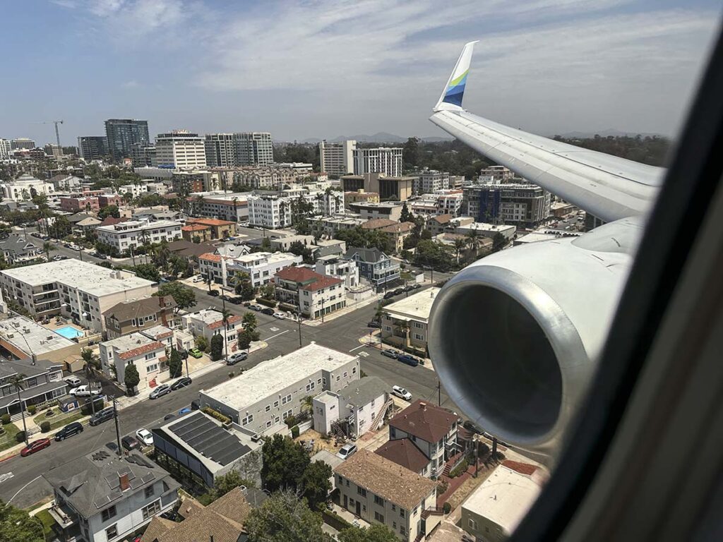 Looking out the window of an Alaska Airlines 737-800 over flying little Italy while on approach into San Diego