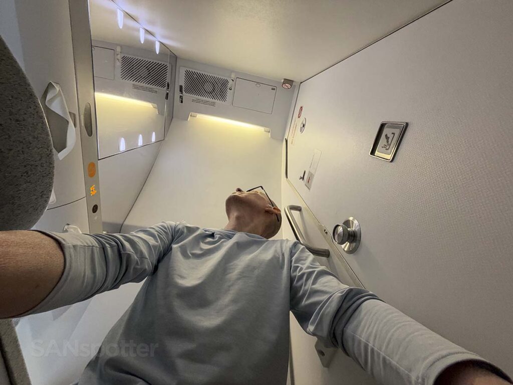Scott Leazenby sitting on the toilet in the Hawaiian Airlines A330-200 Extra Comfort lavatory