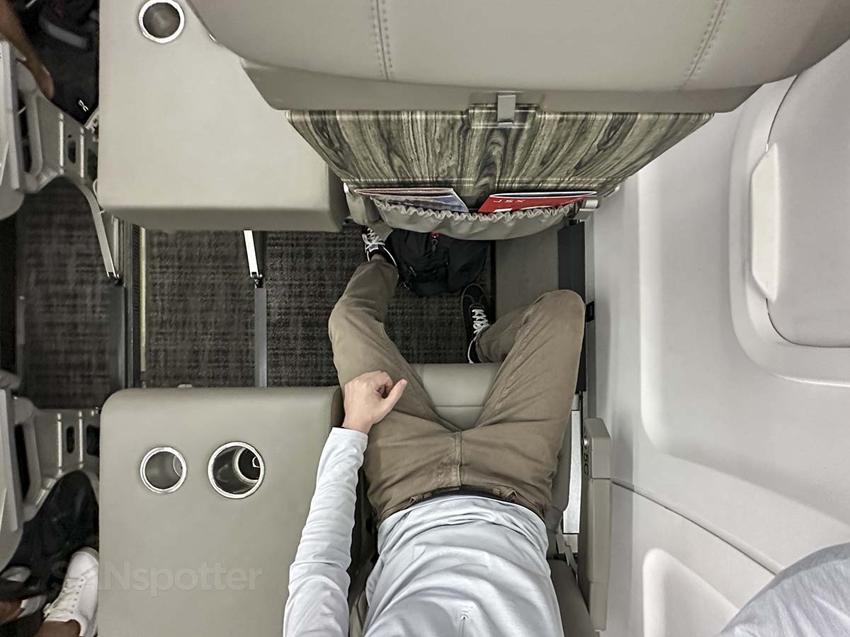 JSX Embraer 145 seat width showing side table with dual insulated cupholders