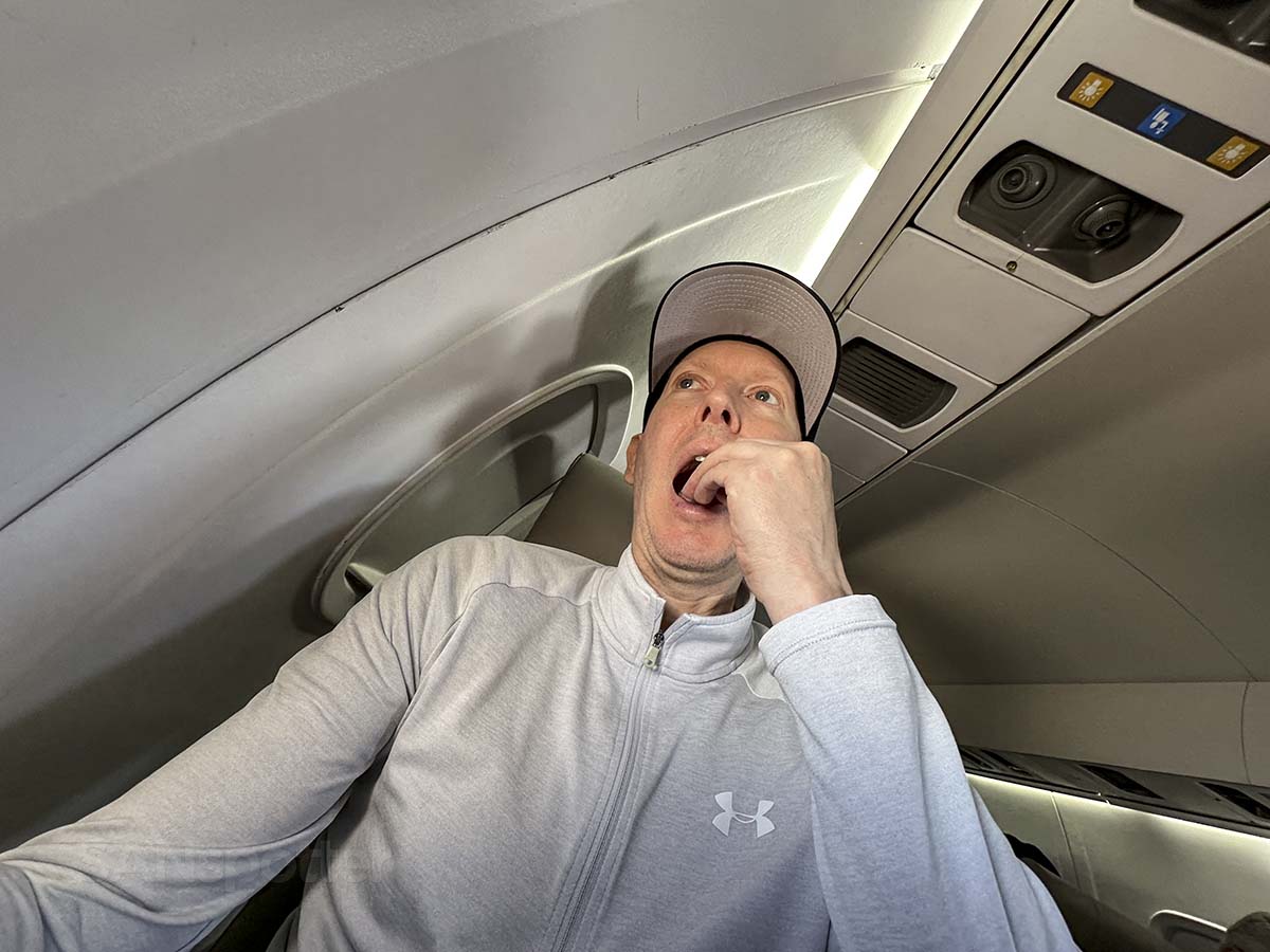Scott Leazenby eating a snack in JSX E145 seat 5C