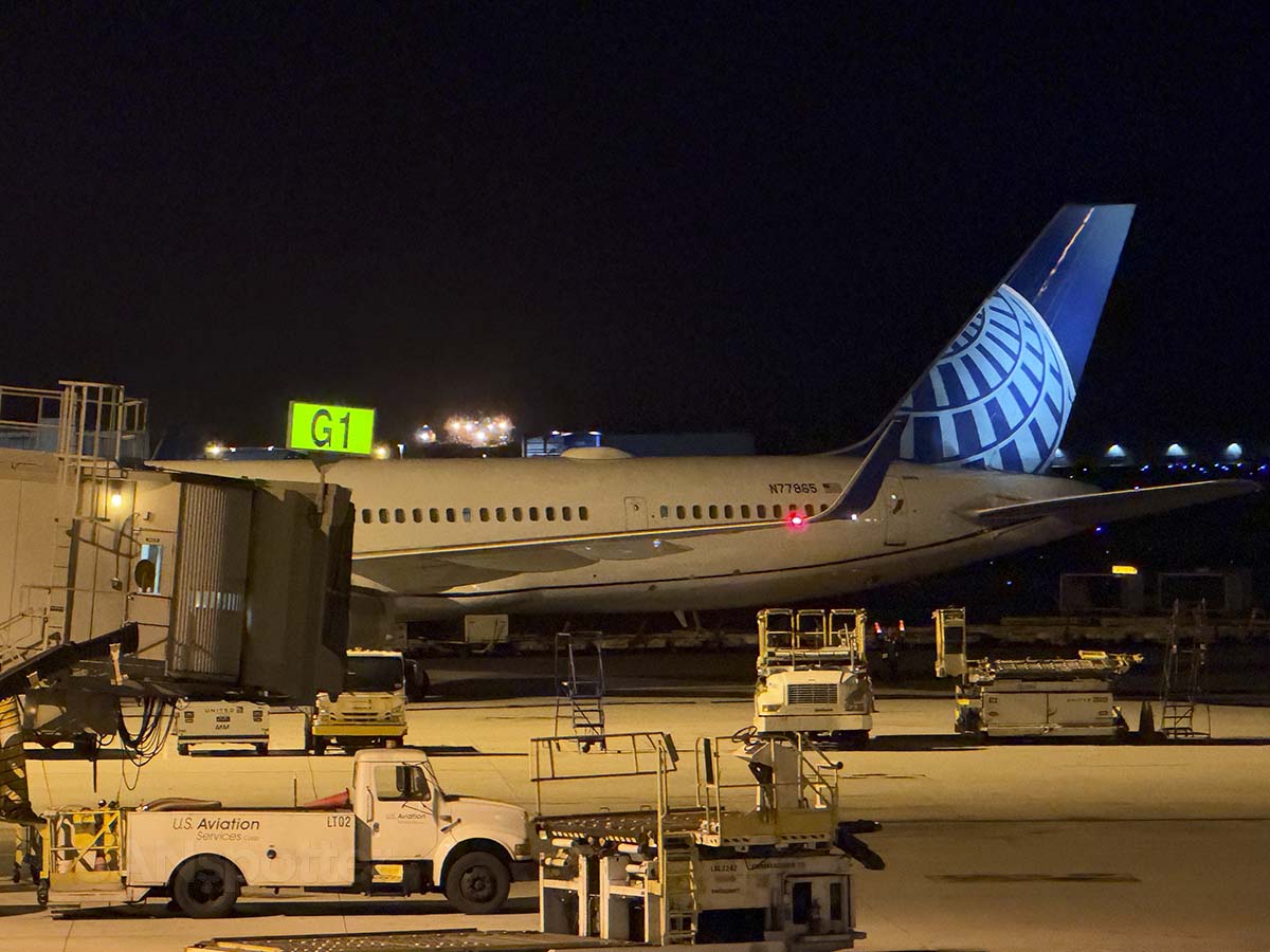 United Airlines 757-300 N77865 parked at gate G2 HNL just before sunrise