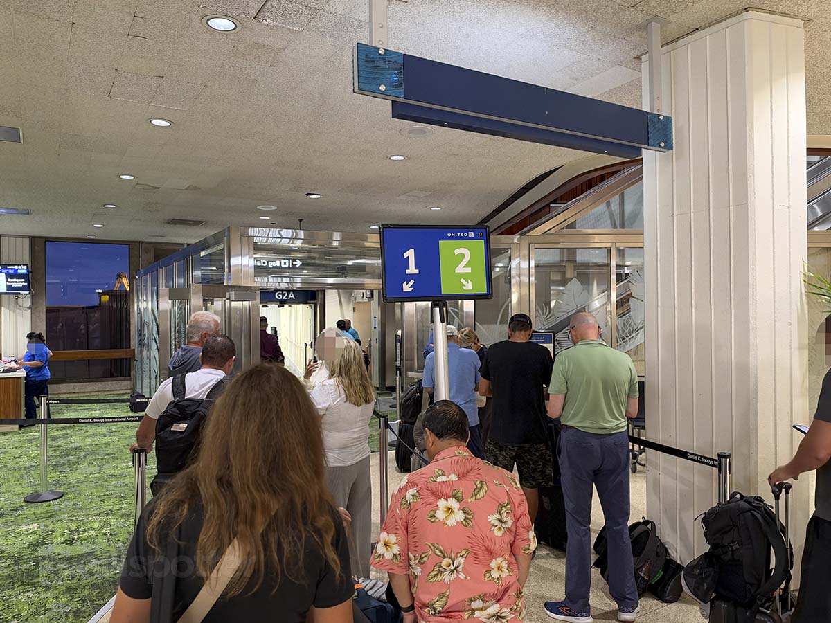 United Airlines Zone 1 and 2 passengers waiting to board at gate G2 Honolulu International Airport