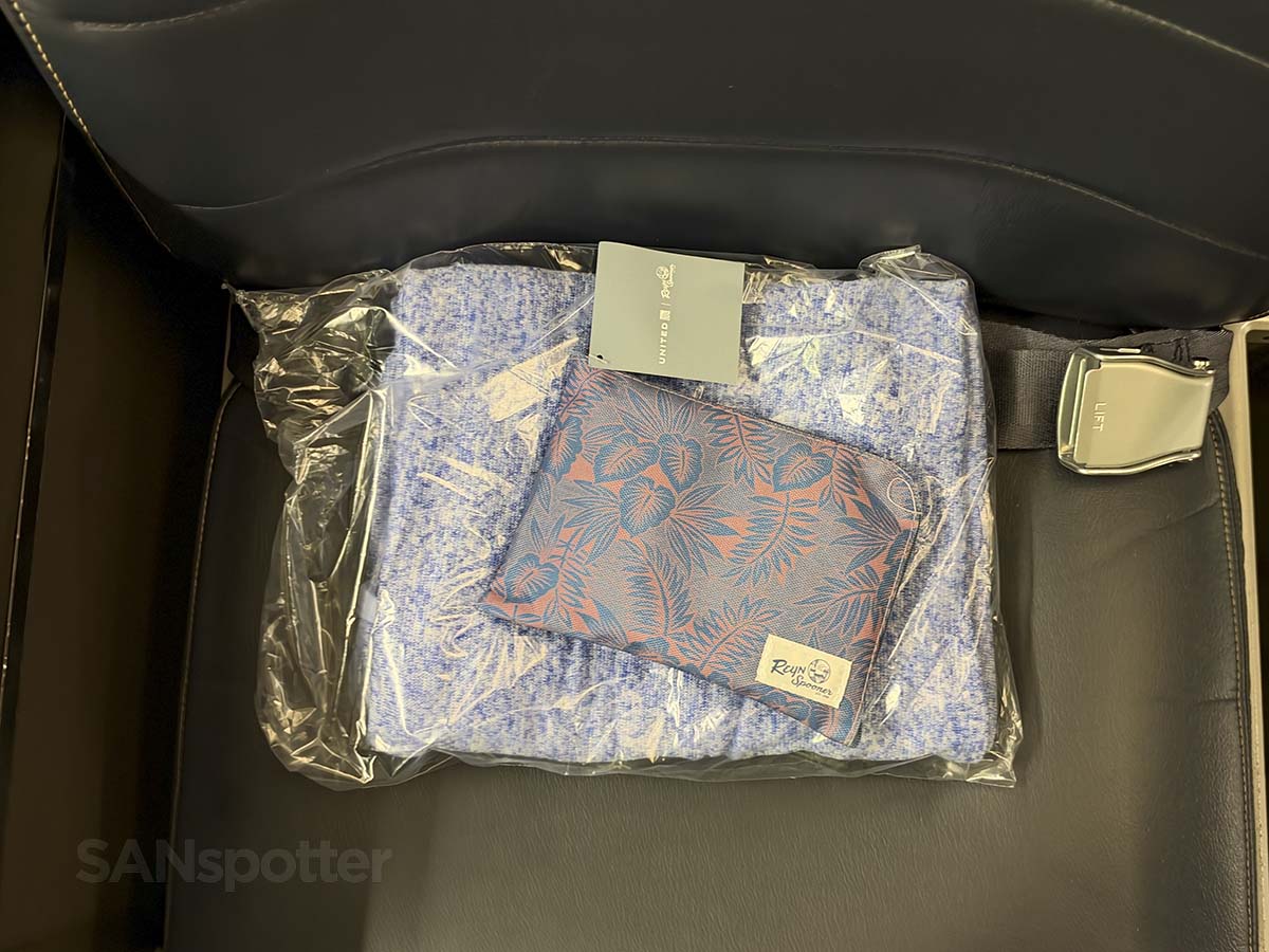 Amenity kit and blanket on my seat in United Airlines 757-300 first class