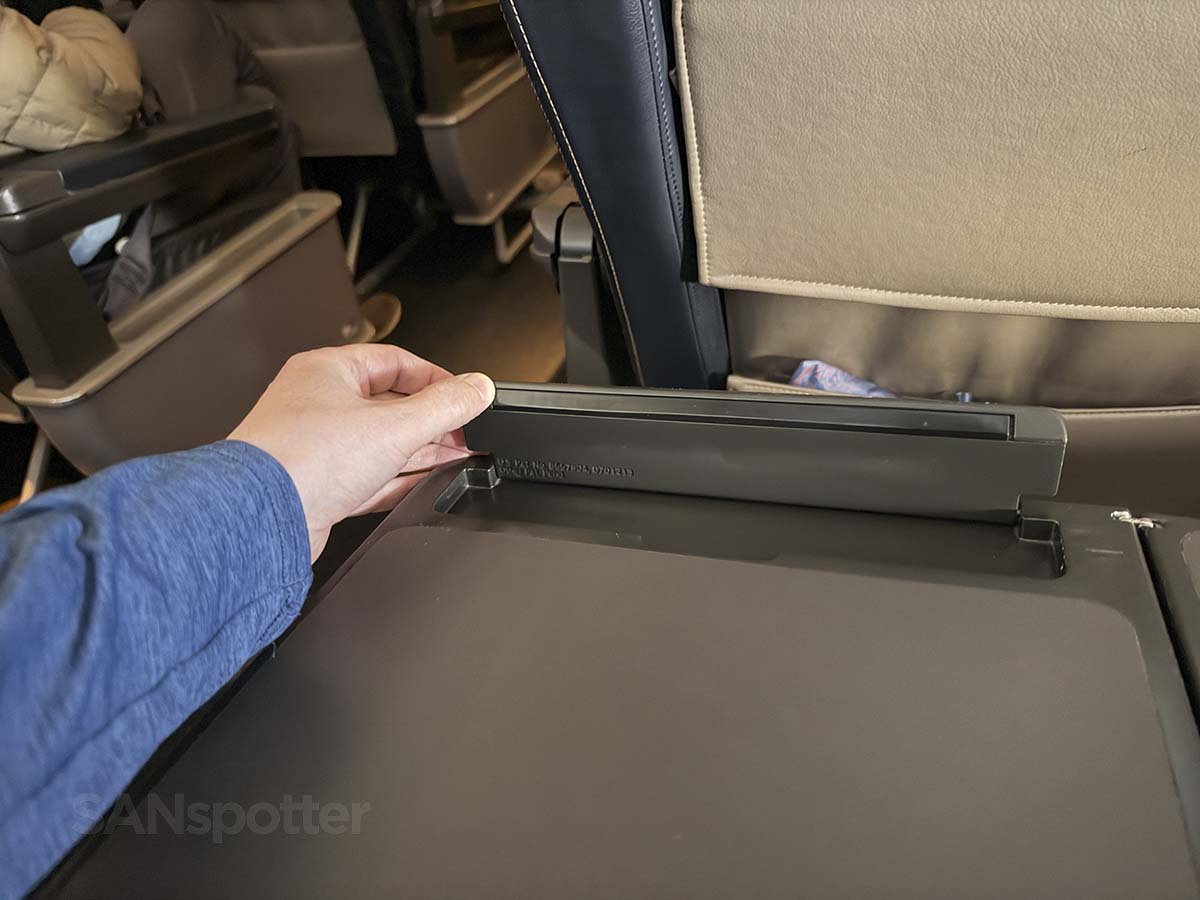 Flip up a personal device holder built into the tray table United Airlines 757-300 first class
