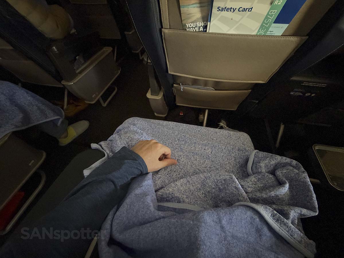 Staying warm in United Airlines 757-300 first class with the complementary blanket