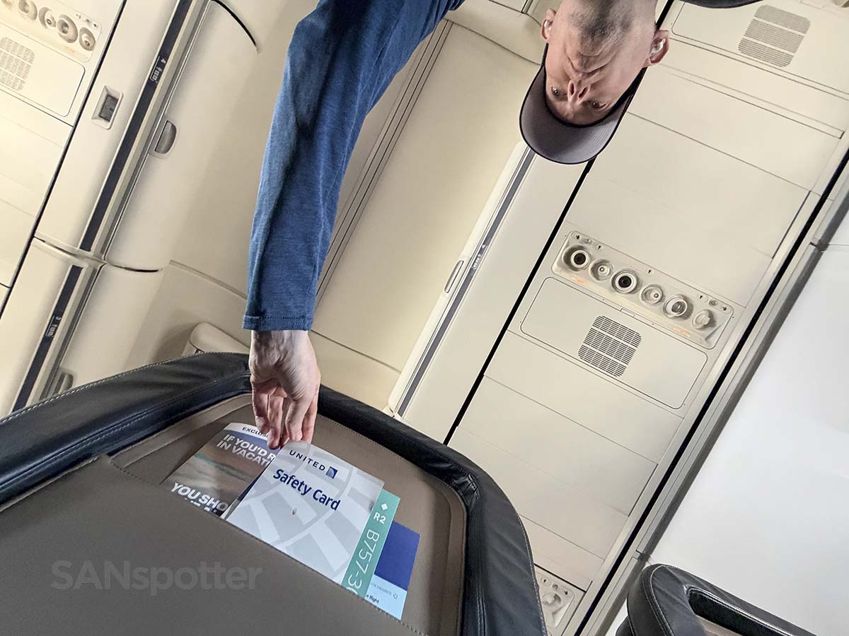 Reaching for the safety card in my first class seat on a United Airlines 757-300