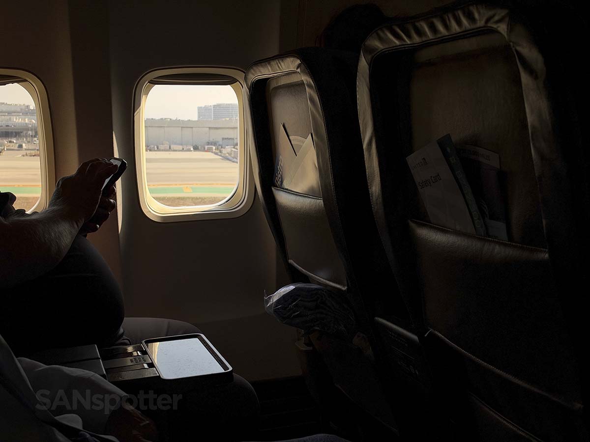 Looking out the window of a United Airlines 757-300 from the aisle seat while touching down on runway 25L LAX
