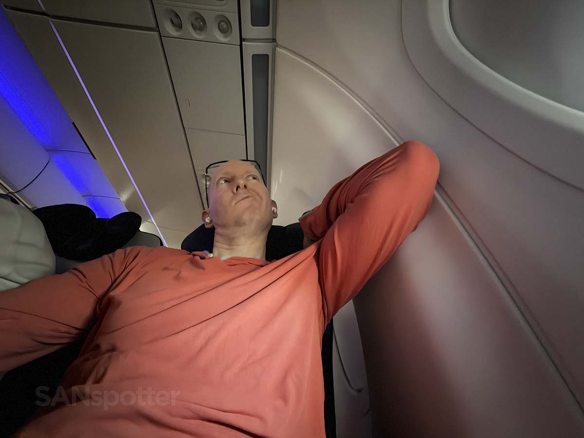 Scott Leazenby adjusting the headrest in United Airlines A321XLR economy