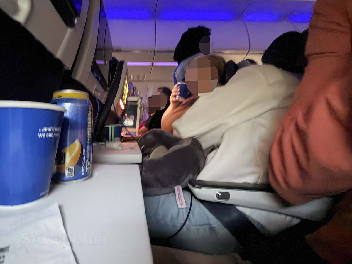 Passengers enjoying free snacks and drinks in United Airlines A321XLR economy