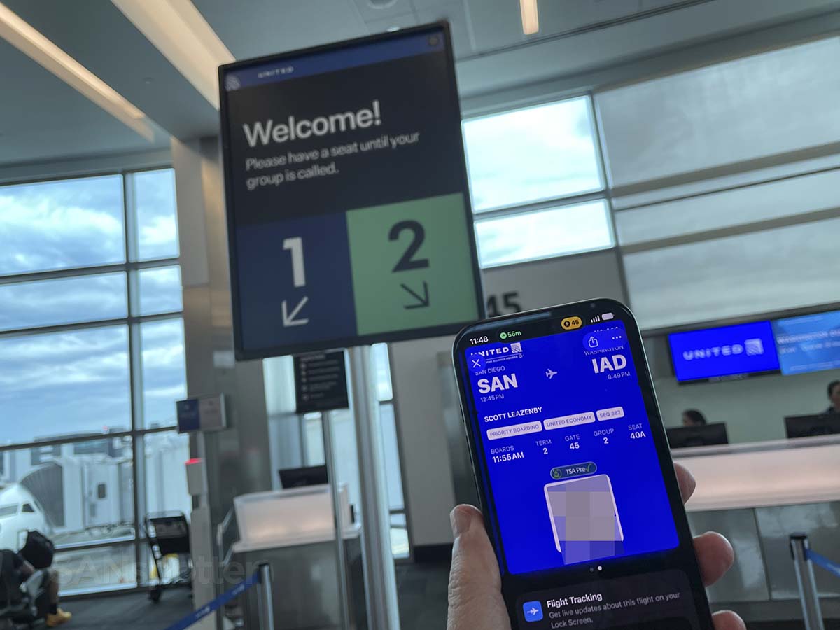 Holding up my United Airlines San Diego to Washington Dulles mobile boarding pass at gate 45 San Diego airport